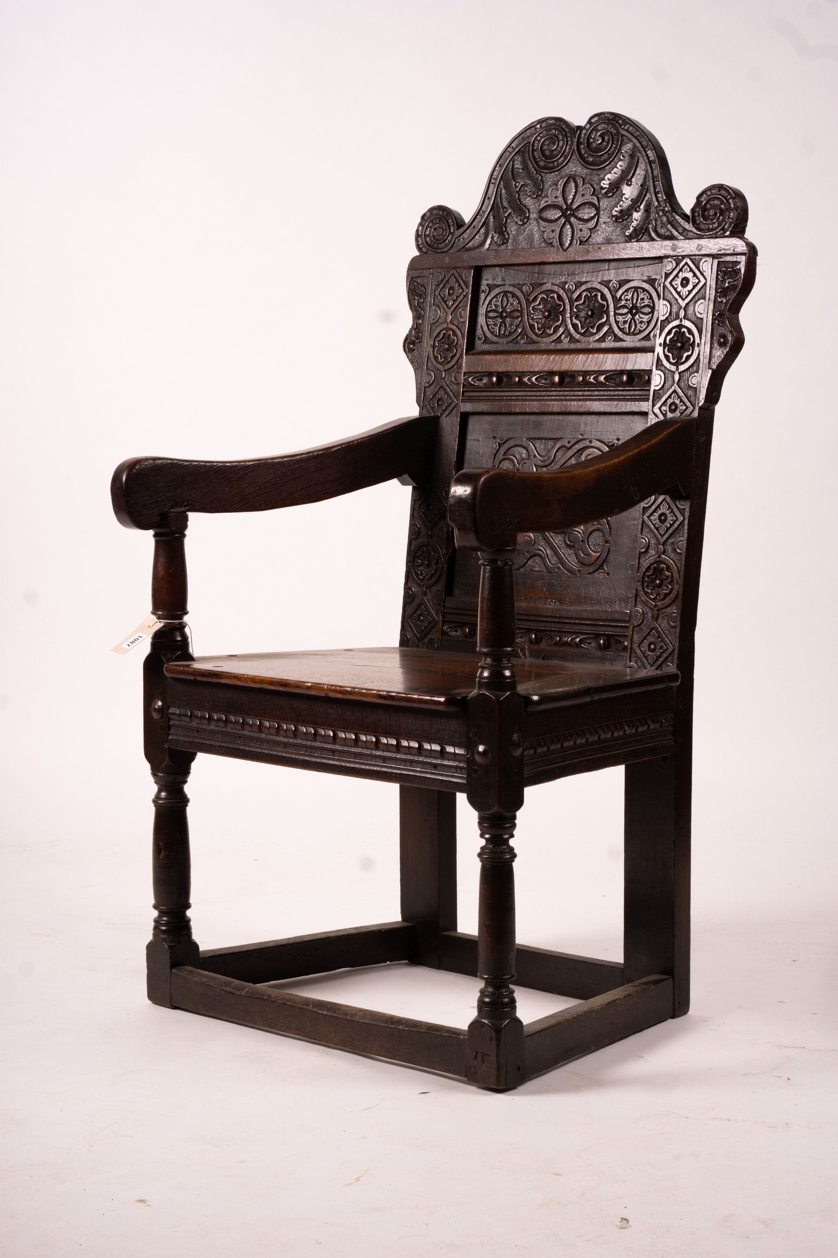 A 17th century Yorkshire area carved oak wainscot chair, width 62cm, depth 48cm, height 118cm